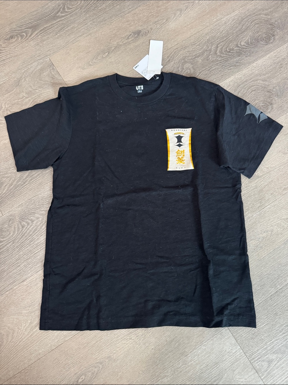 Uniqlo Black Short-Sleeve Tee with Yellow Chest graphic